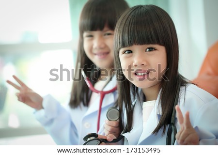 Two little girl kid doctor dressed with stethoscope