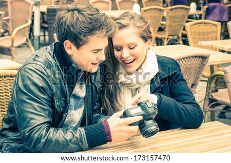 Couple of lovers watching photos on a digital camera 