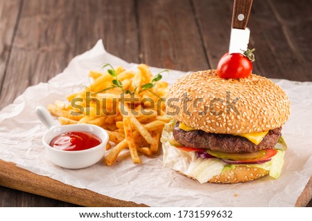 Beef burger served with french fries and tomato ketchup. Royalty-Free Stock Photo #1731599632