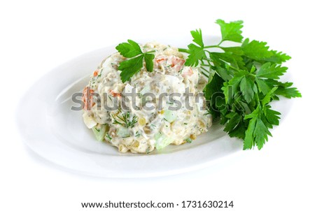 The vinaigrette of various boiled vegetables withe parsley on the plate