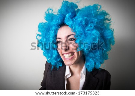 funny blue wig beautiful young businesswoman on gray background