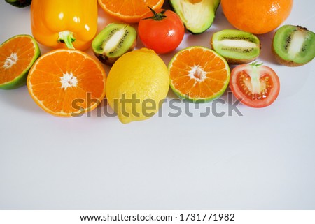 Pictures of fruits and vegetables arranged on a white background with space.