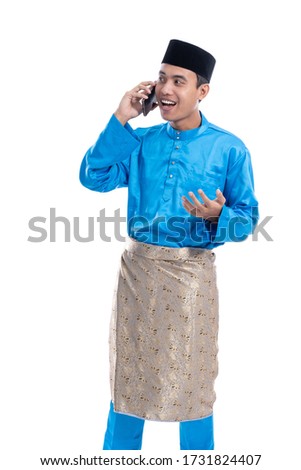 asian male muslim talk on his phone over white background