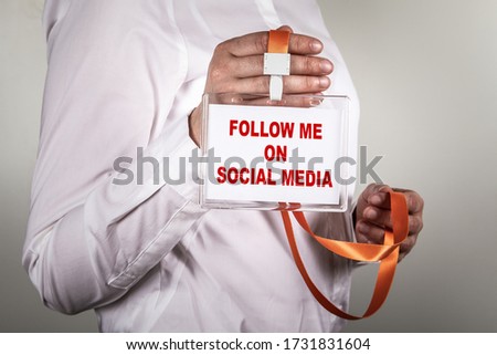 FOLLOW ME ON SOCIAL MEDIA concept. Staff identity with orange lanyard