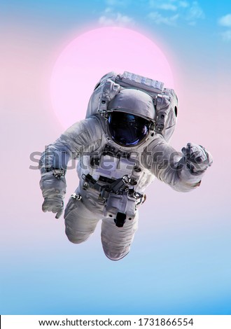 Astronaut on isolated gradient background. Template for poster with spaceman. Elements of this image furnished by NASA Royalty-Free Stock Photo #1731866554