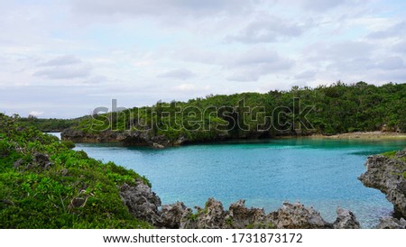 Paradise island, bright idyllic blue ocean water, volcanic stone coast. The incredible color of sea water on the beach of the tropical island of Okinawa Miyakojima
