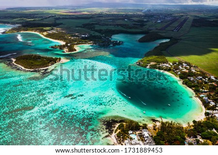 View from the height of the East coast of the island of Mauritius. Flying over the turquoise lagoon and the most beautiful beach of the island of Mauritius in the Belle Mare area