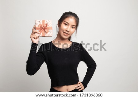 Young Asian woman with a gift box on white background