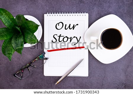 Our Story text, inscription, phrase is written in a notebook that lies on a dark table and a pen. Business concept. Royalty-Free Stock Photo #1731900343
