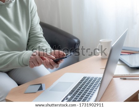 Woman uses the laptop. Close-up of the working place at home. The concept of good job online.