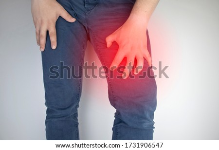 A man suffers from hip pain. The concept of treating a hip joint for trauma, plantation or osteoarthritis. Royalty-Free Stock Photo #1731906547