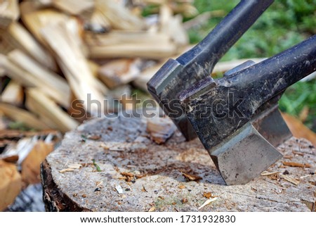 A set of axes and splitters is necessary for harvesting firewood in the countryside.                       