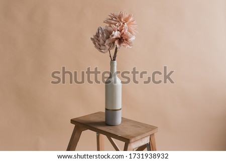 Artificial flowers in a vase. Studio photography of flowers. Decorative flowers with own hands. A minimalist bouquet of artificial flowers  Royalty-Free Stock Photo #1731938932