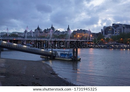 London, UK: view of the river Thames, the Golden Jubilee Bridges and Charing Cross Station by night