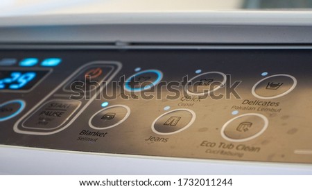 Close up of the clothes washing machine button