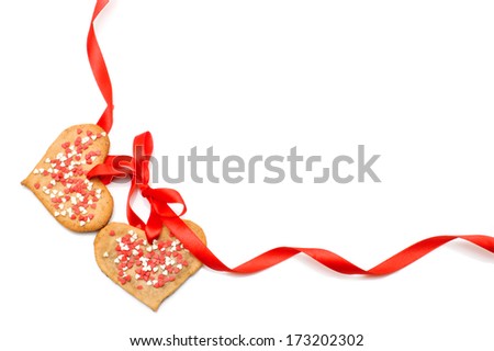 Valentines day - heart shaped cookies for valentine's day and red tape as a frame isolated on white background