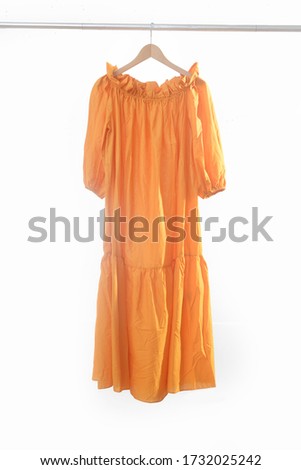 Fashion woman long yellow dress on hanger
