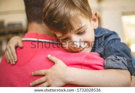 Young Son hugging his Father