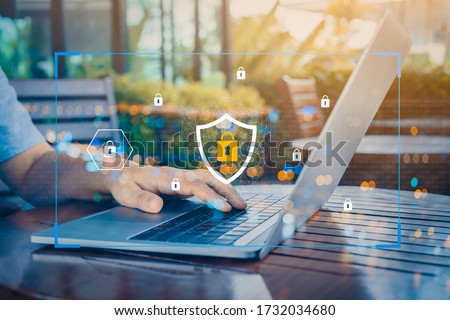Person using a laptop computer with technology cybersecurity and privacy concept. protection and safe data for global network security. Royalty-Free Stock Photo #1732034680