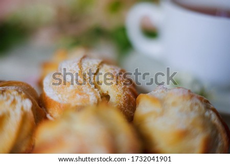 Blurred background with profiteroles with boiled condensed milk and cream.