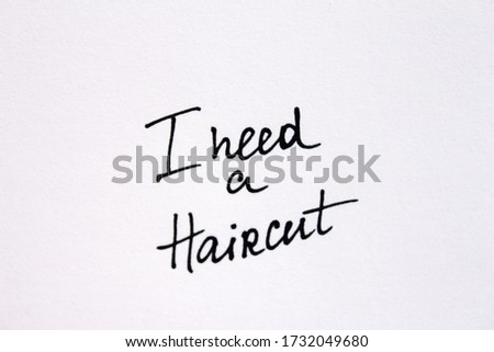 I need a Haircut! Handwritten message on a white background.