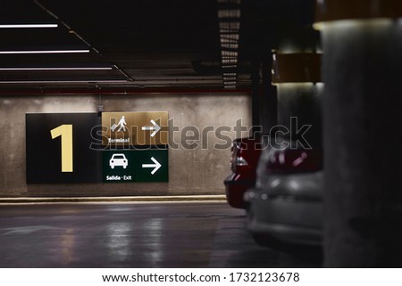 view of signage signs in underground airport parking.