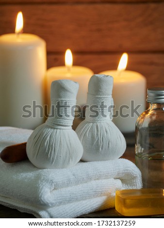 Spa composition with coconut oil massage and herbal compress ball for relaxation. Royalty-Free Stock Photo #1732137259