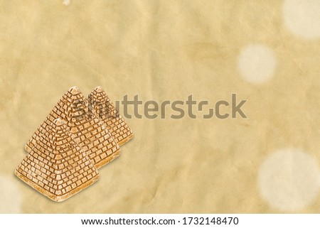 Several pyramids of sand on obsolete paper with bokeh. Background texture minimal tourism. Creative layout