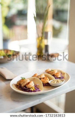 tacos with shrimp on the table in restaurant
