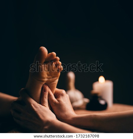 Professional foot massage close up. Authentic shot of luxury spa treatment. Charming light. Shallow depth of field. Stylized and colored. Royalty-Free Stock Photo #1732187098