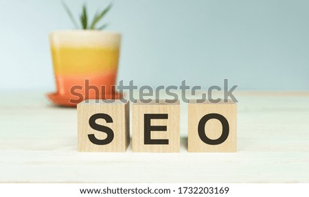 SEO text on wooden cubes on a wood background