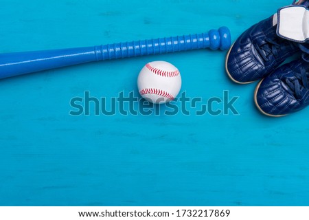 Baseball equipment on blue wooden background. Online workout concept.
