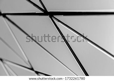 A metal wall made of many triangles. Triangles with sharp corners and gradient transitions.
