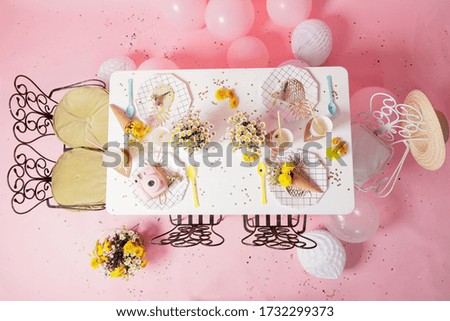 Pink birthday party decoration. Dinner table decoration ideas. Flowers, pink camera, cake time plate and decor stuff.