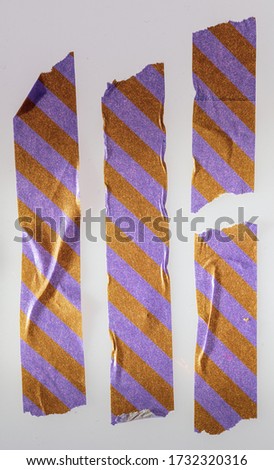 set of paper stickers on white plastic background with streak pattern (gold and purple)