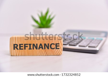 Refinance word on wooden block. Office table background. Royalty-Free Stock Photo #1732324852