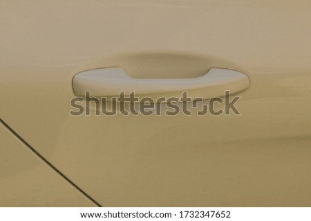 Close-up taken of handle of white automobile,background.