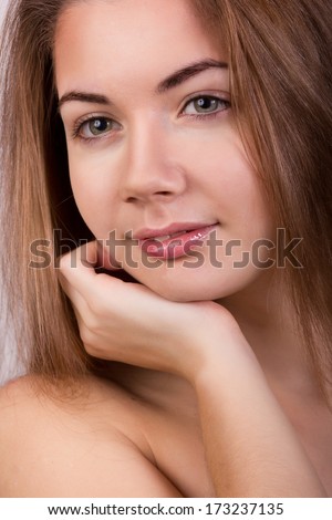 Studio portrait of a beautiful young woman with blond long hair without makeup