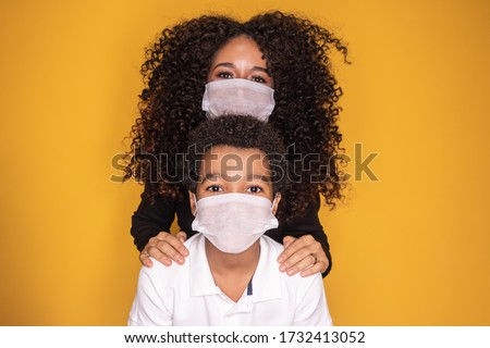 Portrait of young African American mother with toddler son using mask. mother and son wearing mask to protect covid 19, quarantine. Stay at home concept.  Royalty-Free Stock Photo #1732413052