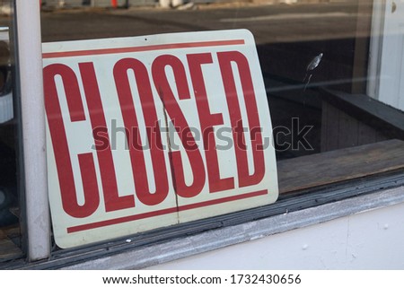 A closed sign in a store front window due to the COVID-19 Pandemic