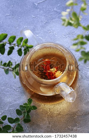 Blooming chinese tea in glass teapot, top view