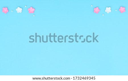 Pink and white flowers made of foamiran on blue background. Mother day, Valentine day, Wedding, Birthday concept. Greeting or invitation card. Flat lay with copy space.