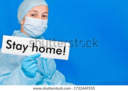 Young doctor showing a sign to stay home.