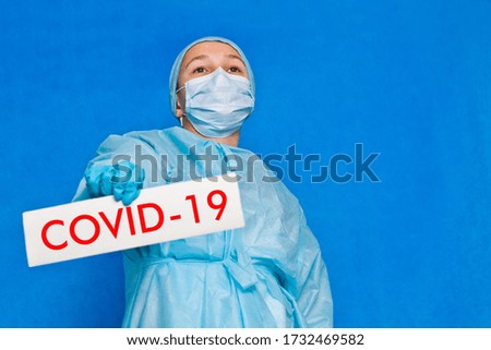 Young doctor showing a sign saying covid-19.