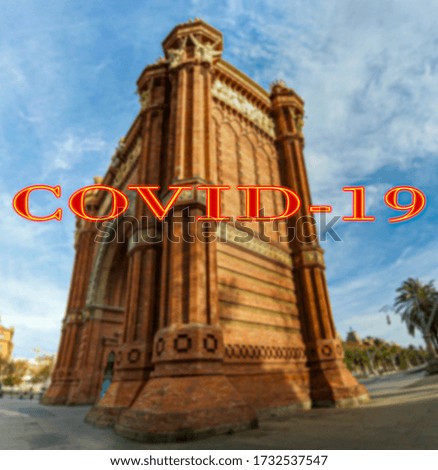 Coronavirus in Barcelona, Spain. Covid-19 sign on a blurred background. Concept of COVID pandemic and travel in Europe. Arc de Triomf