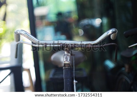 Rusted old handlebars and brakes on a blurred bokeh background