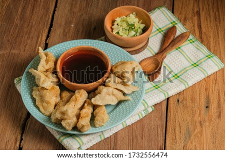 pempek served on rustic wooden table. Pempek is traditional food from indonesia. made of fish and tapioca served with rich sweet and special sour sauce or vinegar sauce called cuka