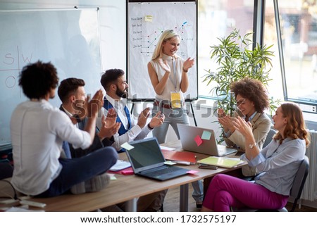 Coworkers applauding a colleague. Applause at a business meeting. Congratulating a success.  Royalty-Free Stock Photo #1732575197