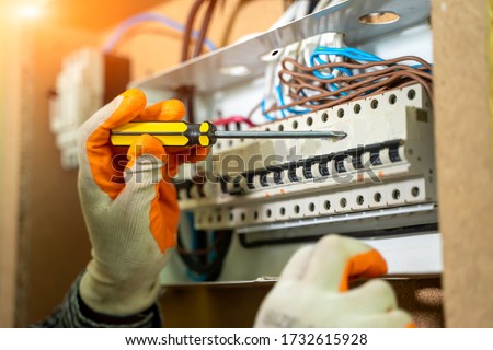Electrician Installing Socket In New House,Electrician working safely on switches and sockets of a residential electrical system. Royalty-Free Stock Photo #1732615928