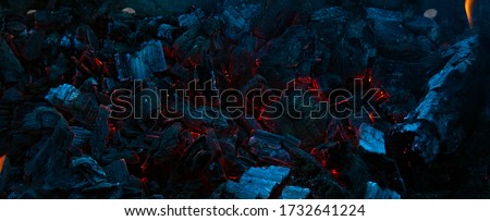 Burning coals in the dark, smoldering coal. Bright red sparks of fire. Background. Royalty-Free Stock Photo #1732641224